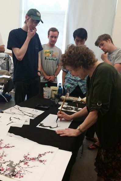 Picture of artist demonstrating plum branch on rice paper
