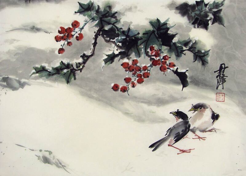 holly with red berries and two birds in the snow