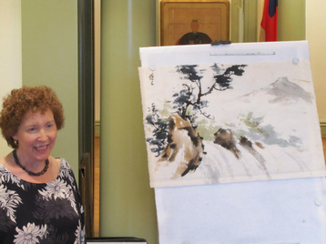Artist demonstrates a waterfall in Chinese brush painting technique at Millennium Gate Museum, Atlanta, GA