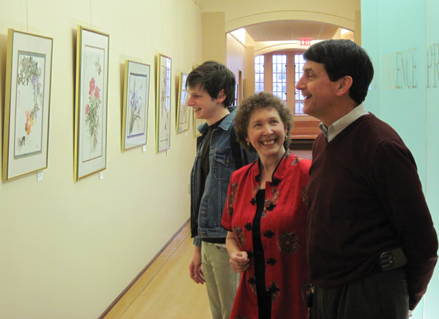 Picture of Rev Tom Crittenden and student discussing Virginia Tech exhibition with artist