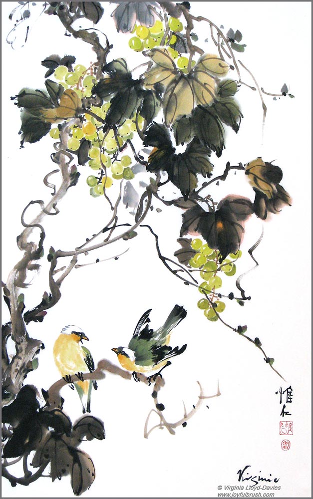 Yellow grapes and two birds on vine