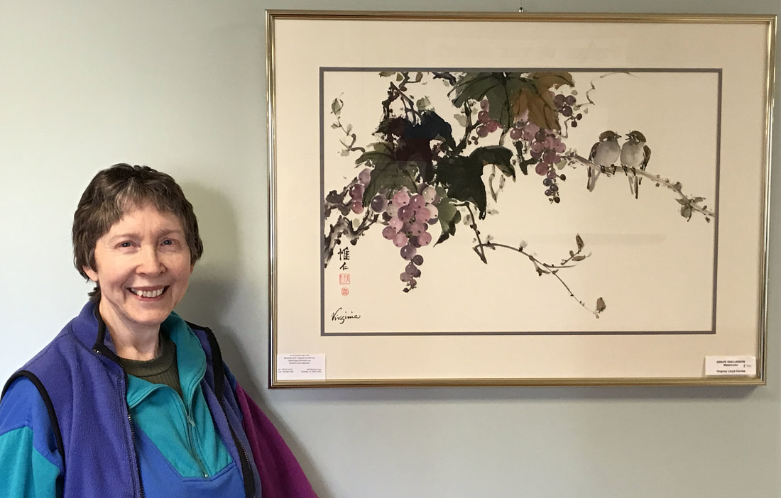 Virginia Lloyd-Davies with painting of grapes and birds at Potomac Falls Health & Rehab Center, Sterling VA
